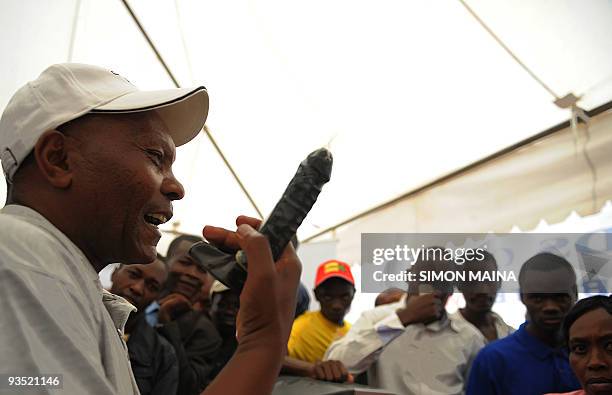 Kenyan health worker shows how to use a condom at the Kenyatta International Centre on December 1, 2009 during celebrations for World Aids Day in...