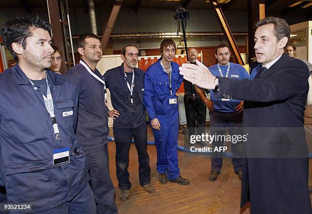 French President Nicolas Sarkozy gestures as he talks with workers during a visit at the industrial group CNIM , on December 1, 2009 in La...