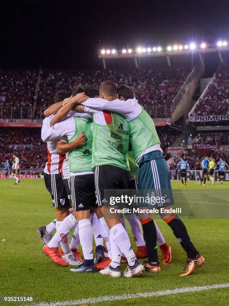 Ignacio Scocco of River Plate celebrates with teammates after scoring the second goal of his team during a match between River Plate and Belgrano as...