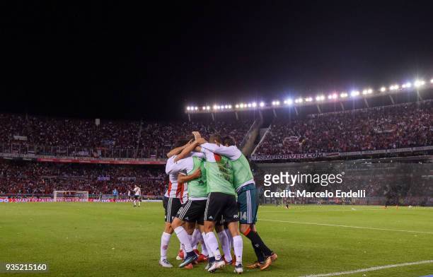 Ignacio Scocco of River Plate celebrates with teammates after scoring the second goal of his team during a match between River Plate and Belgrano as...
