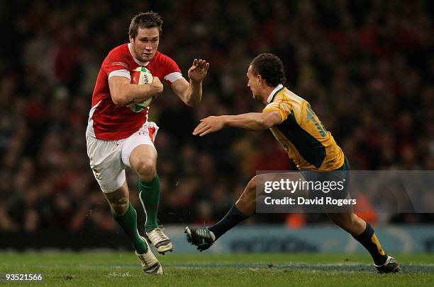 Andrew Bishop of Wales is challenged by Quade Cooper of Australia during the Invesco Perpetual Series match between Wales and Australia at the...