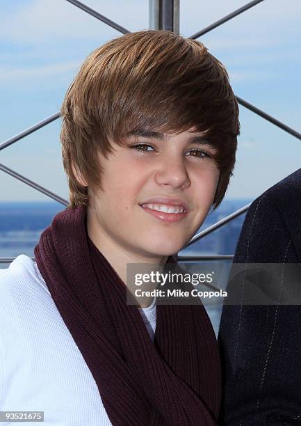 Singer Justin Bieber poses at the The Empire State Building in honor of Jumpstart's 4th Annual National Read for the Record Day on October 8, 2009 in...