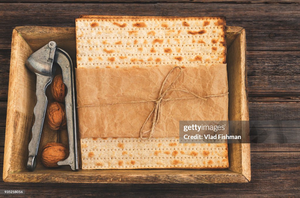 Pack of matzah or matza on a vintage wood background presented as a gift.