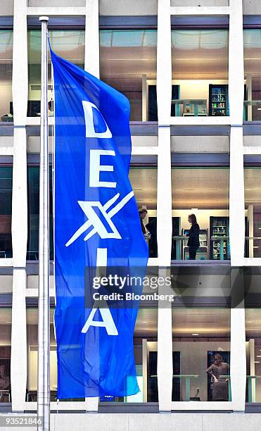 Flags bearing the Dexia SA company logo fly outside the central branch and administrative building in Brussels, Belgium, on Monday, Nov. 30, 2009....