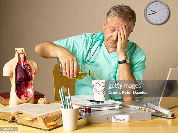 senior doctor with stress and alcohol problems. - drogados imagens e fotografias de stock