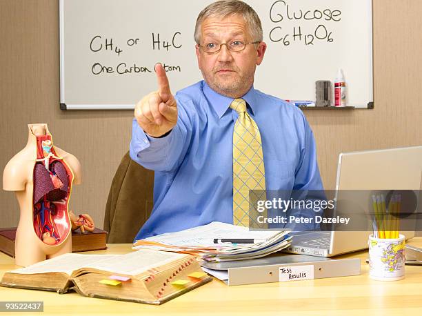 mature science teacher pointing finger. - parsons green stockfoto's en -beelden