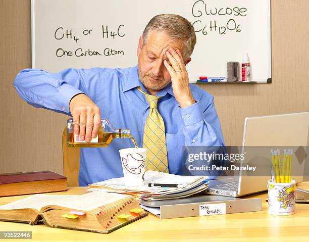 senior teacher with stress and drink problems. - hangover work stock pictures, royalty-free photos & images