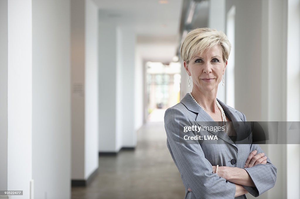 Confident Businesswoman Standing In Hallway