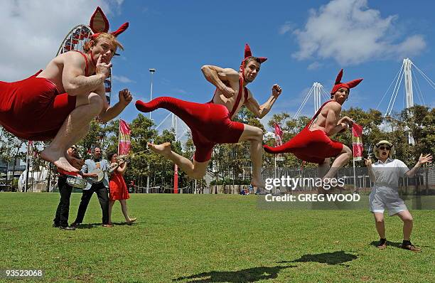 Performers from the internationally acclaimed Australian Circus Oz masquerading as kangaroos, Luke Taylor , Jeremy Davies and Paul O'Keeffe , jump in...