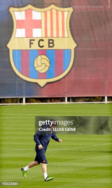 Barcelona's Argentinian forward Lionel Messi runs during a training session at Ciutat Esportiva Joan Gamper, near Barcelona, on November 27 two days...