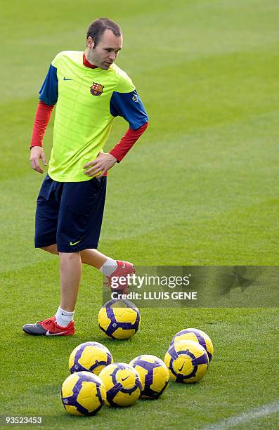 Barcelona's midfielder Andres Iniesta takes part in a training session at Ciutat Esportiva Joan Gamper, near Barcelona, on November 27 two days...