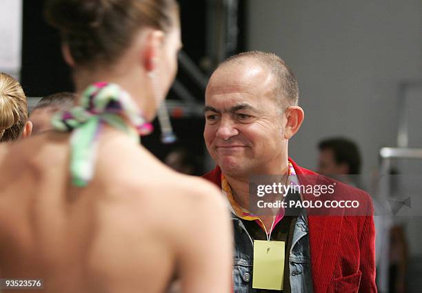 French fashion designer Christian Lacroix looks at a model backstage during his Spring/Summer 2005 women's collection for the Italian line Pucci at...