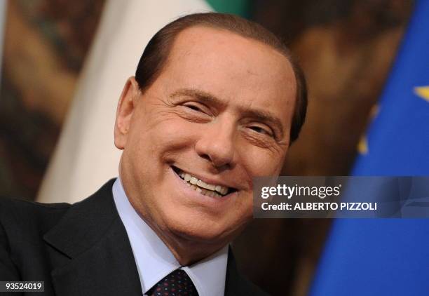 Italy's prime minister Silvio Berlusconi looks on as arrives to meet the head of government of San Marino at Chigi Palace in Rome on November 27,...