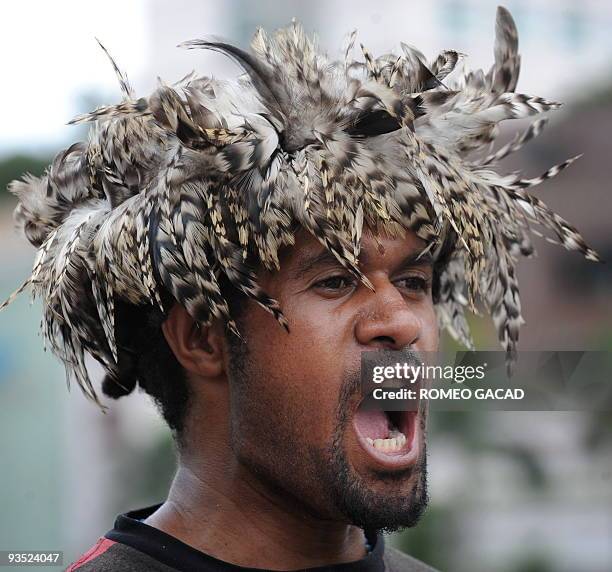 Papuan activist wearing a traditional tribal feather cap shouts "free Papua" during a rally in Jakarta on December 1, 2009. In Jayapura Indonesian...