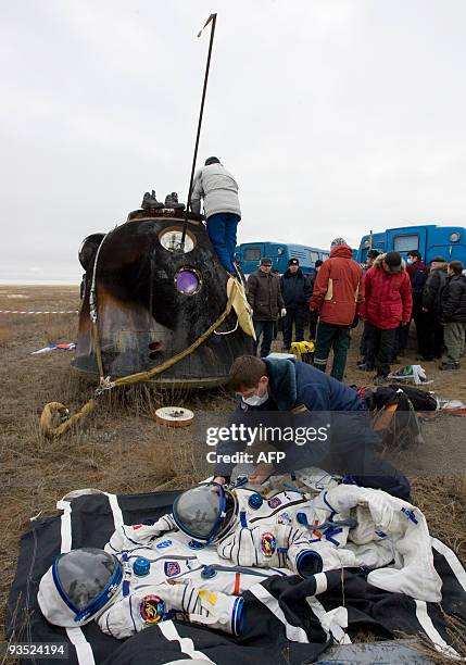 Russian specialsit checks space suits in front of the Soyuz space capsule of the International Space Station crew of European Space Agency astronaut...