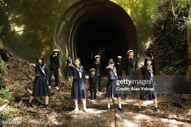 school uniformed actors in front of a tunnel - 廃墟　日本 ストックフォトと画像