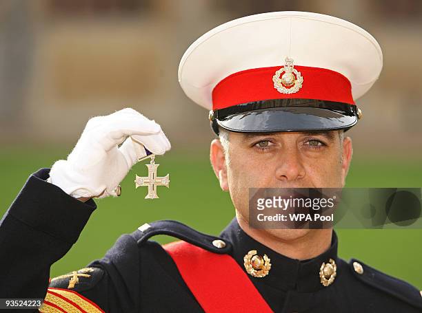 Sergeant Noel Connolly, Royal Marines, holds his Military Cross, which he received from The Queen at an investiture ceremony , at Windsor Castle...