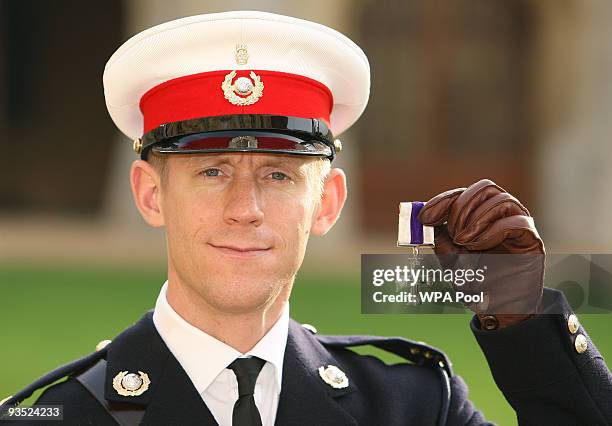 Major Richard Cantrill, Royal Marines, holds his Military Cross, which he received from The Queen at an investiture ceremony , at Windsor Castle...