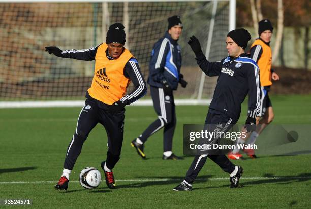 Didier Drogba and Deco of Chelsea during a training session at their training ground on December 1, 2009 in Cobham, England.