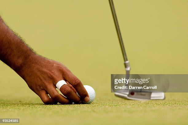 Tiger Woods places his ball on the green during the final round of the 2009 AT&T National hosted by Tiger Woods, held at Congressional Country Club...