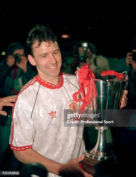 Bryan Robson of Manchester United celebrates with the trophy after the European Cup Winners' Cup Final between Manchester United and Barcelona at the...