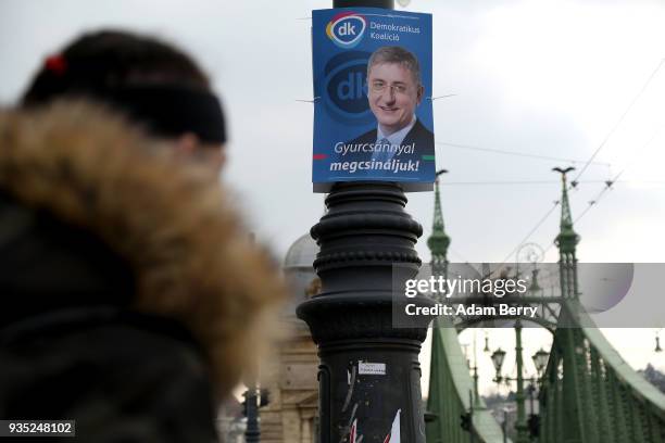 Poster featuring former Hungarian prime minister and Democratic Coalition party candidate Ferenc Gyurcsany hangs prior to the upcoming Hungarian...