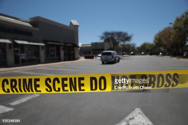Crime scene tape blocks access to the public as FBI agents collect evidence at a FedEx Office facility following an explosion at a nearby sorting...