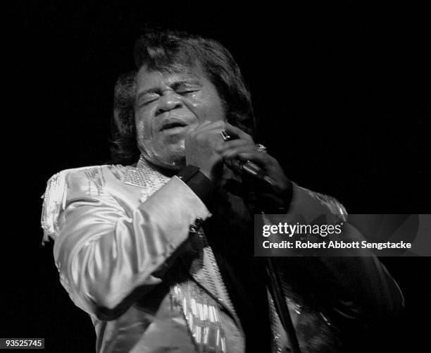 Singer James Brown clutches the microphone as he performs at the African International House's 12th African Festival of the Arts, held at Washington...