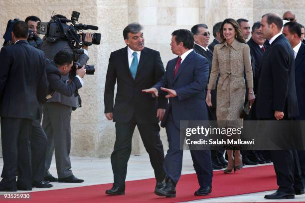 Turkish President Abdullah Gul and his wife Hayrunnisa Gul are received by Jordan's King Abdullah and his wife Queen Rania upon their arrival for a...