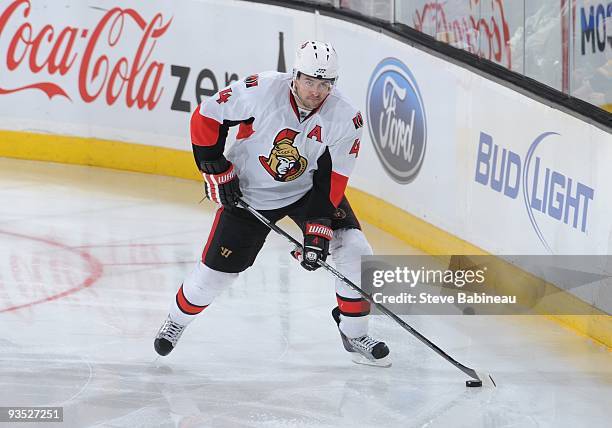 Chris Phillips of the Ottawa Senators skates with the puck against the Boston Bruins at the TD Garden on November 28, 2009 in Boston, Massachusetts.