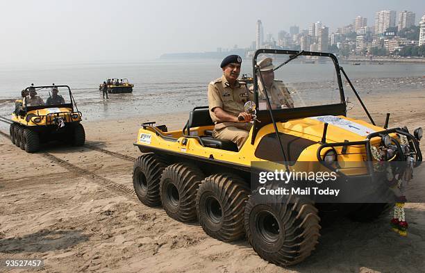 Police personnel display all-terrain vehicles inducted for city police force for patrolling the costal area at Girgaum Chowpatty on the eve of the...