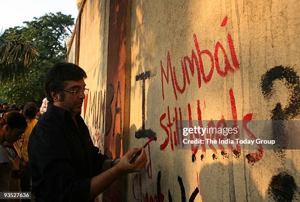 People pay homage to the victims of November 26 terror attacks on its first anniversary in Mumbai.