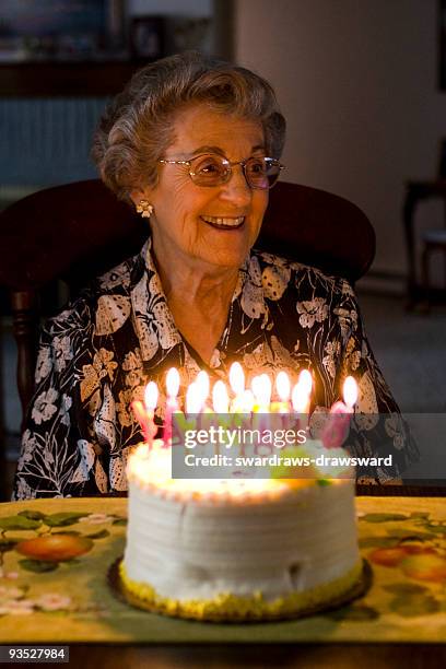 elderly woman celebrates birthday - senior woman birthday stock pictures, royalty-free photos & images