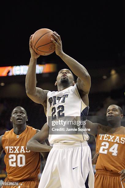 Brad Wanamaker of the Pittsburgh Panthers takes a shot against Alexis Wangmene and Justin Mason ofthe Texas Longhorns during the CBE Classic...