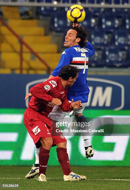 Daniele Mannini of UC Sampdoria and Antonio Filippini of AS Livorno jump for a header during the TIM Cup match between UC Sampdoria and AS Livorno at...
