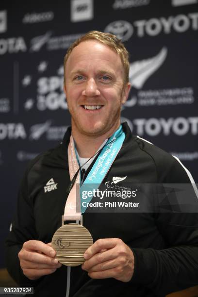 Paralympic skier Corey Peters poses with his bronze medal during the New Zealand Paralympic Winter Games Team Arrival at Auckland Airport on March...