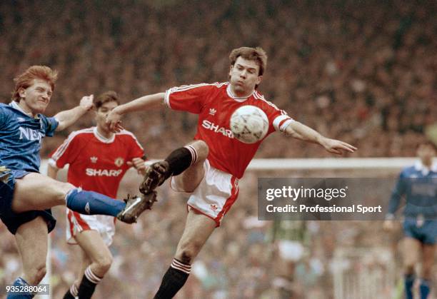 Brian McClair of Manchester United is challenged by Stuart McCall of Everton during a Barclays League Division One match at Old Trafford on March 2,...