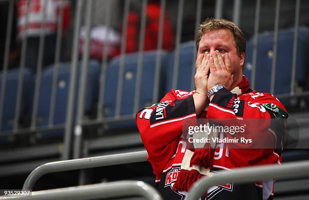 Fan of Haie looks dejected after the end of the Deutsche Eishockey Liga game between Koelner Haie and Hannover Scorpions at Lanxess Arena on December...