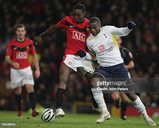 Danny Welbeck of Manchester United clashes with Sebastien Bassong of Tottenham Hotspur during the Carling Cup Quarter-Final match between Manchester...