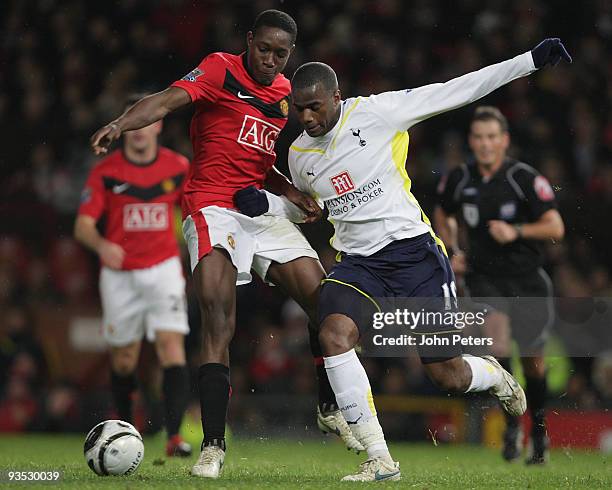 Danny Welbeck of Manchester United clashes with Sebastien Bassong of Tottenham Hotspur during the Carling Cup Quarter-Final match between Manchester...