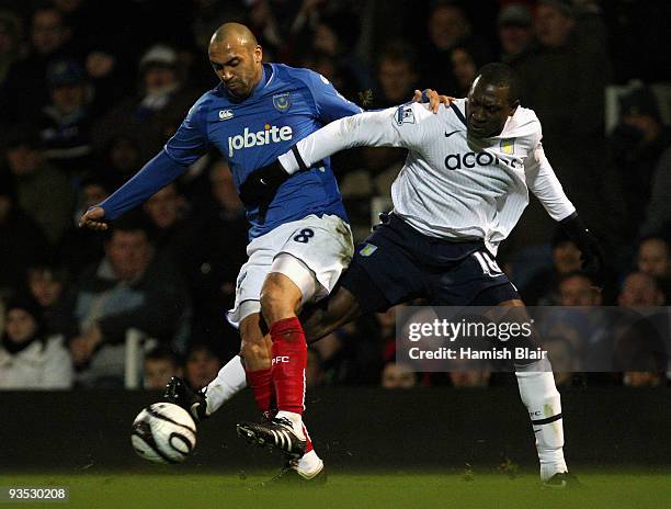 Anthony Vanden Borre of Portsmouth contests with Emile Heskey of Aston Villa during the Carling Cup quarter final match between Portsmouth and Aston...