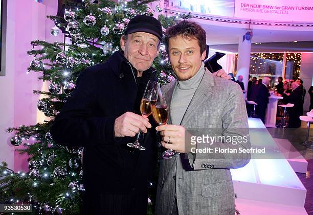 Actors Michael Mendl and Roman Knizka pose in front of a christmas tree at the launch of the BMW art advent calender 2009 at a BMW branch on December...