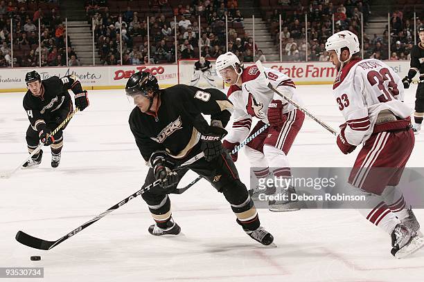 Adrian Aucoin of the Phoenix Coyotes defends against Teemu Selanne of the Anaheim Ducks during the game on November 29, 2009 at Honda Center in...