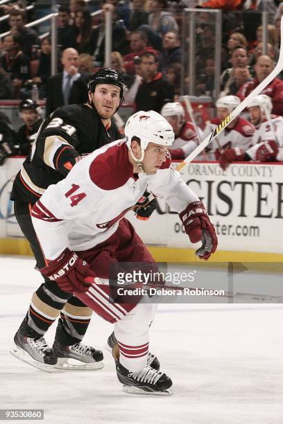 Taylor Pyatt of the Phoenix Coyotes gets a push from behind from James Wisniewski of the Anaheim Ducks during the game on November 29, 2009 at Honda...