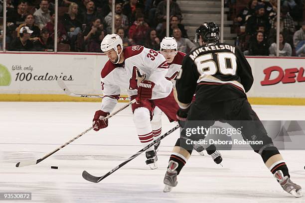 Adrian Aucoin of the Phoenix Coyotes drives the puck center ice against Brendan Mikkelson of the Anaheim Ducks during the game on November 29, 2009...