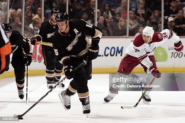 Daniel Winnik of the Phoenix Coyotes races for the puck from behind as Ryan Getzlaf of the Anaheim Ducks controls the puck during the game on...