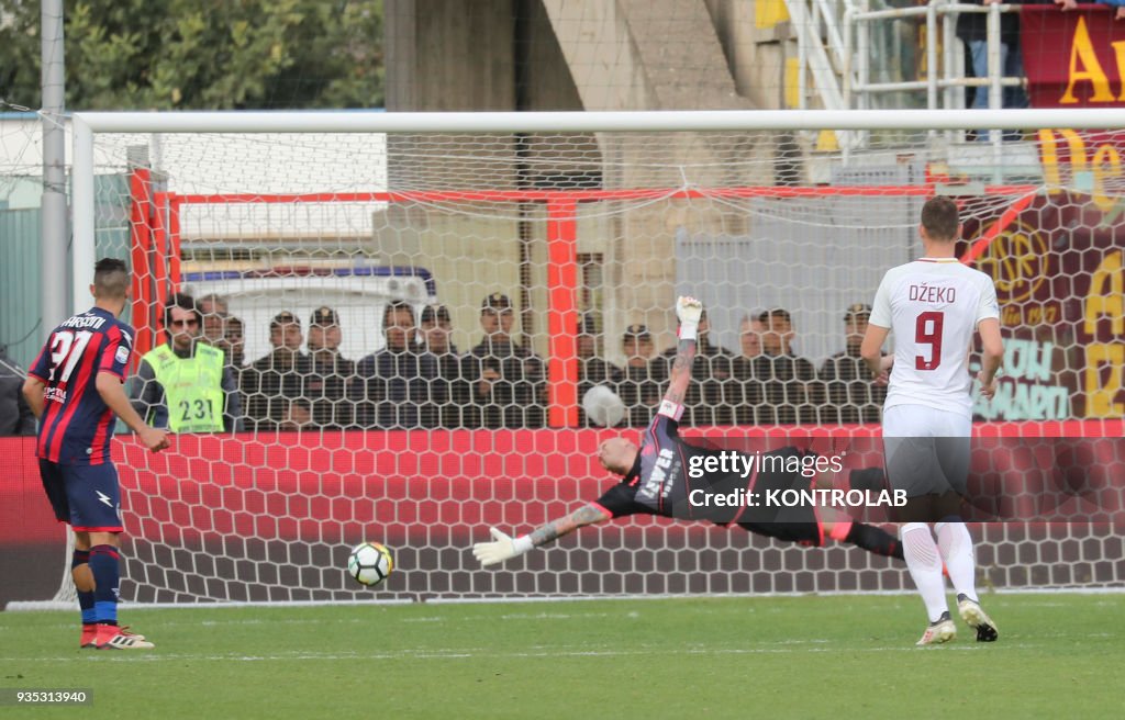 Crotone's Italian goalkeeper Alex Cordaz dives as the ball...