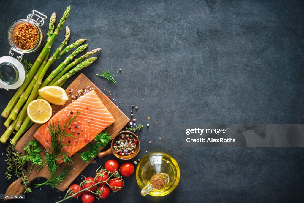 Fresh salmon fillet with aromatic herbs, spices and vegetables