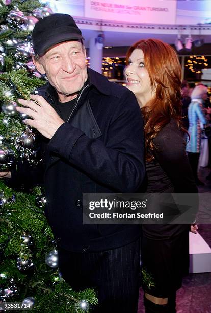 Actors Michael Mendl and Claudia Wenzel pose in front of a christmas tree at the launch of the BMW art advent calendar 2009 at a BMW branch on...