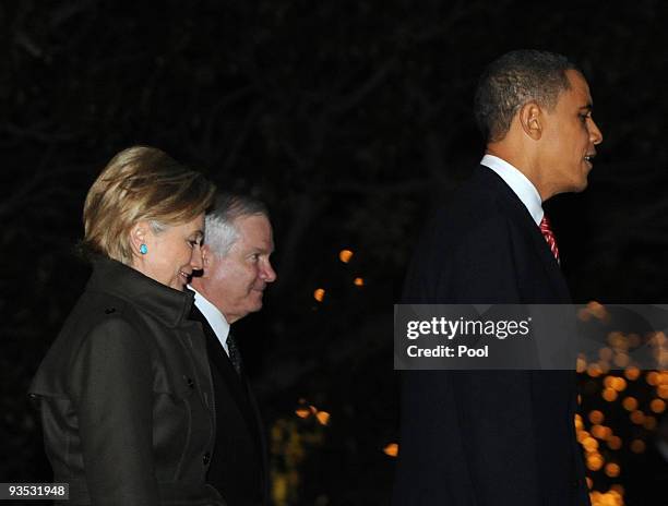 President Barack Obama , Secretary of State Hillary Clinton and Defense Secretary Robert Gates walk across the South Lawn of the White House to board...